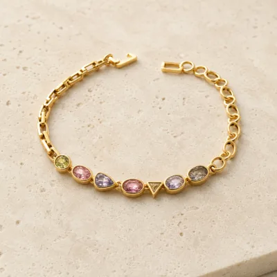Pulseira dourada cristais 83977-01 modelo D elos assimétricos coloridos sobre pedra clara