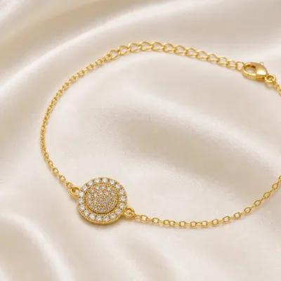pulseira com medalhão circular dourado em cetim marfim, referência 85203-05