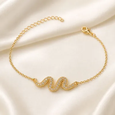 pulseira com ondas de cristais dourado em cetim marfim, referência 85203-06