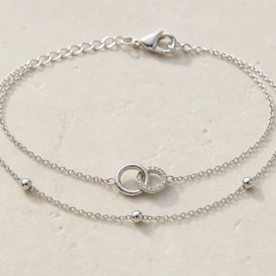 pulseira dupla com elos entrelaçados prateado em pedra clara de tom quente, referência 85203-08