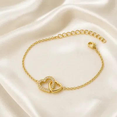 pulseira com corações entrelaçados dourada em cetim marfim, referência 85203-09