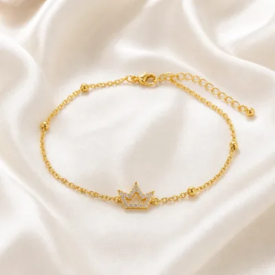 pulseira com coroa de cristais dourado em cetim marfim, referência 85203-12