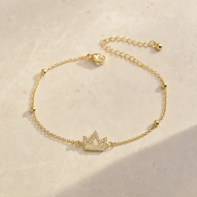 pulseira com coroa de cristais dourado em pedra clara de tom quente, referência 85203-12