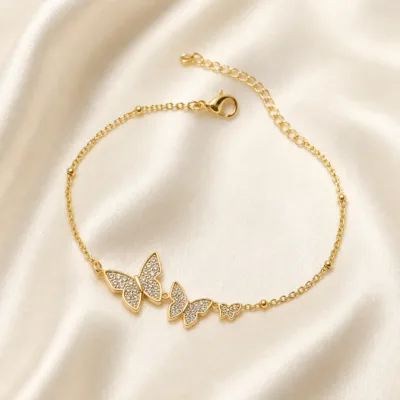 pulseira com três borboletas de cristais dourado em cetim marfim, referência 85204-16