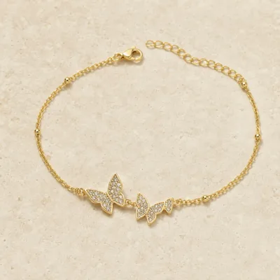 pulseira com três borboletas de cristais dourado em pedra clara de tom quente, referência 85204-16