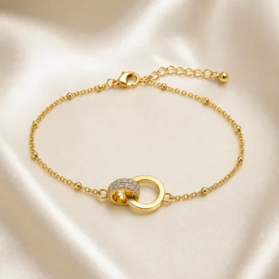 pulseira com dois círculos entrelaçados dourado em cetim marfim, referência 85204-17