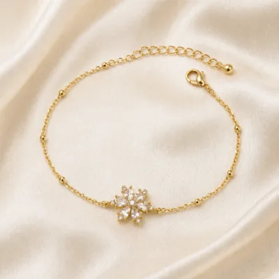 pulseira com flor de oito cristais dourado em cetim marfim, referência 85204-23