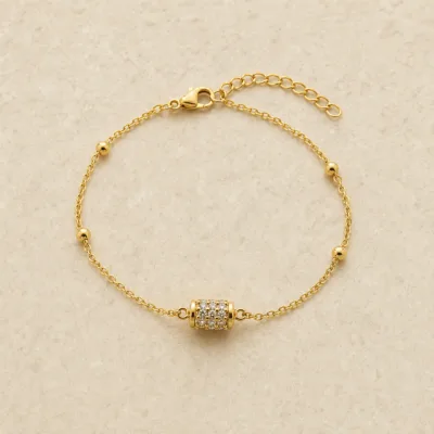 pulseira com cilindro pavé de cristais dourado em pedra clara de tom quente, referência 85204-25