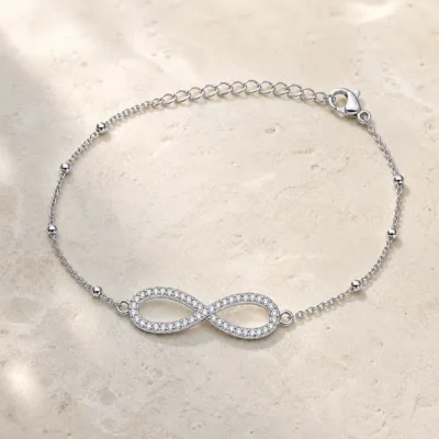 pulseira infinito pavé prateada em pedra clara de tom quente, referência 85204-28