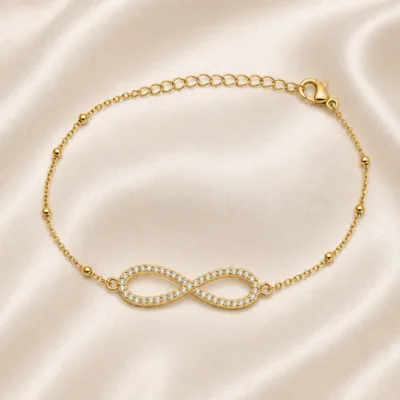 pulseira infinito pavé dourada em cetim marfim, referência 85204-28