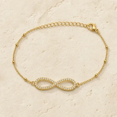 pulseira infinito pavé dourada em pedra clara de tom quente, referência 85204-28