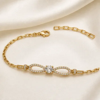 pulseira dourada laço infinito com cristal em cetim marfim, referencia 85250-01