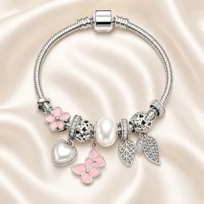pulseira prateada rosa com pérola em cetim marfim, referencia 85327-2