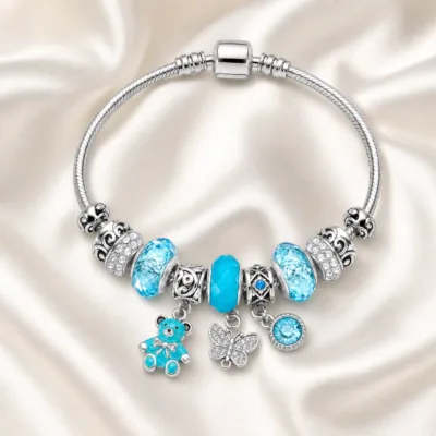 pulseira prateada turquesa com urso em cetim marfim, referencia 85327-6