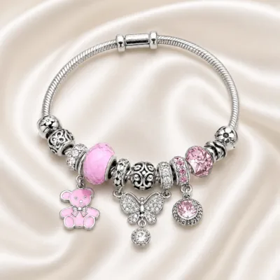 pulseira prateada rosa com urso em cetim marfim, referencia 85327-6
