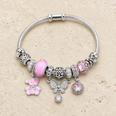 pulseira prateada rosa com urso em pedra clara de tom quente, referencia 85327-6