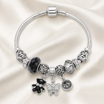 pulseira prateada preta com urso em cetim marfim, referencia 85327-6