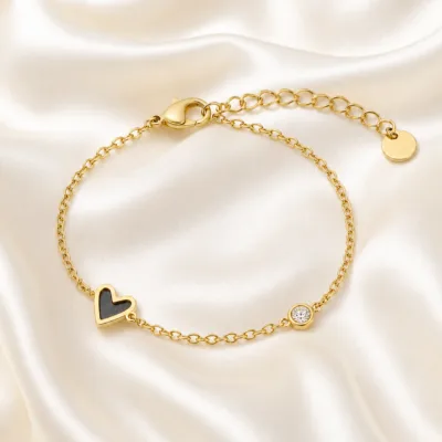 pulseira dourada com coração preto e cristal em cetim marfim, referência 85382-3