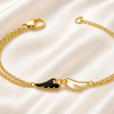 pulseira dourada com asas pretas em cetim marfim, referência 85383-2