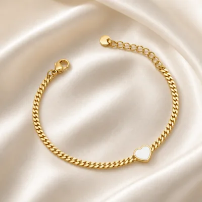pulseira dourada com coração branco e corrente cubana em cetim marfim, referência 85384-4