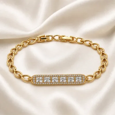 pulseira dourada com barra de cristais em cetim marfim, referencia 85402-2