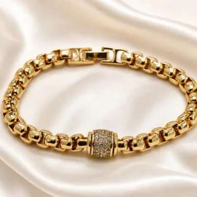 pulseira dourada com cilindro de zircões em cetim marfim, referencia 85403-3
