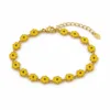 Pulseira dourada de flores amarelas - fundo branco