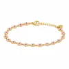 Pulseira dourada de flores rosa com centros pretos, uma pulseira, vista em fundo branco