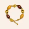 pulseira de contas ovais coloridas, variante dourada, pedra clara, referência 85443