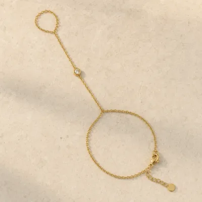 pulseira de mão dourada minimalista com cristal em pedra clara de tom quente, referência 85473-1
