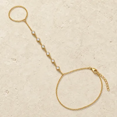 pulseira de mão dourada com seis cristais em pedra clara de tom quente, referência 85474-3