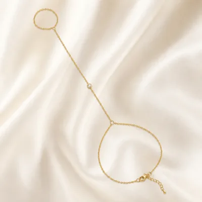 pulseira de mão dourada com cristal único em cetim marfim, referência 85474-4