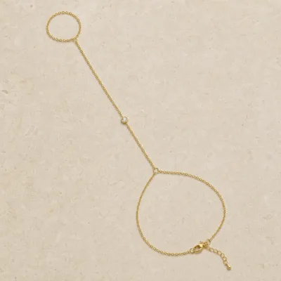 pulseira de mão dourada com cristal único em pedra clara de tom quente, referência 85474-4