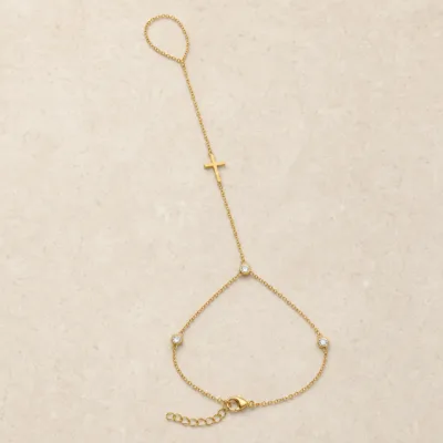 pulseira de mão dourada com cruz e três cristais em pedra clara de tom quente, referência 85475-2