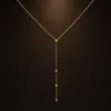 colar dourado em Y com círculos, fundo branco, referência 85477-3