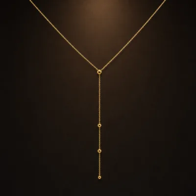 colar dourado em Y com círculos, fundo branco, referência 85477-3