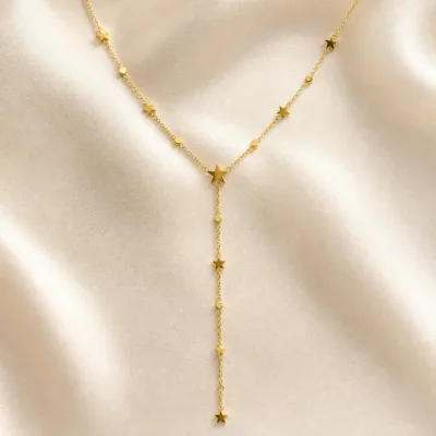 colar dourado em Y com estrelas, pedra clara de tom quente, referência 85479-1
