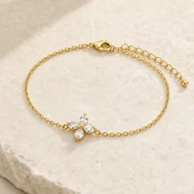 pulseira dourada com flor de cristais, pedra clara de tom quente, referência 85588-4