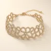 Pulseira Larga Dourada com Laços Entrelaçados — A — Dourado
