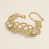 Pulseira Larga Dourada com Dois Centros Redondos — A — Dourado