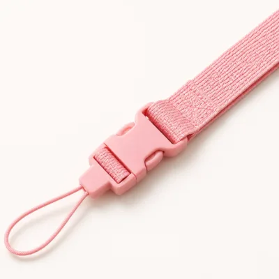 Detalhe do tecido rosa, fecho destacável e laço para telemóvel