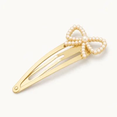 Gancho de cabelo dourado com laço de pérolas