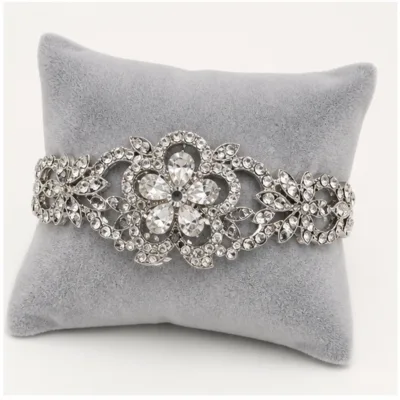 Pulseira prateada com flor num expositor de joalharia
