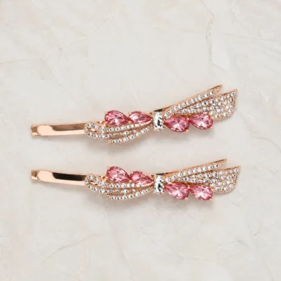 Par de ganchos rosa-dourados com laço e cristais transparentes