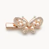 Gancho bico de pato rosa-dourado com borboleta e pérolas