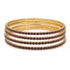Conjunto de quatro pulseiras douradas com cristais roxo-escuro