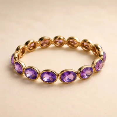 Pulseira dourada com pedras ovais de vidro roxo