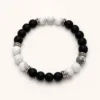 Pulseira de pedra natural preta e branca com detalhes prateados