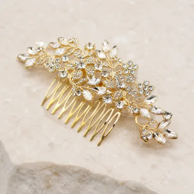Pormenor do pente dourado com flores, folhas e cristais