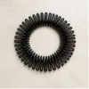 Travessa circular flexível preta para cabelo